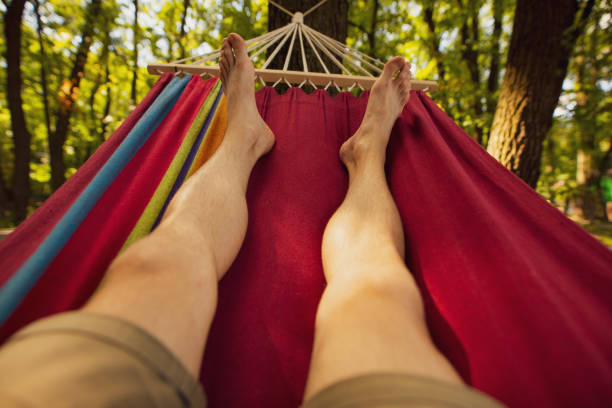 istock Male legs relaxing lying on hammock 1254337962