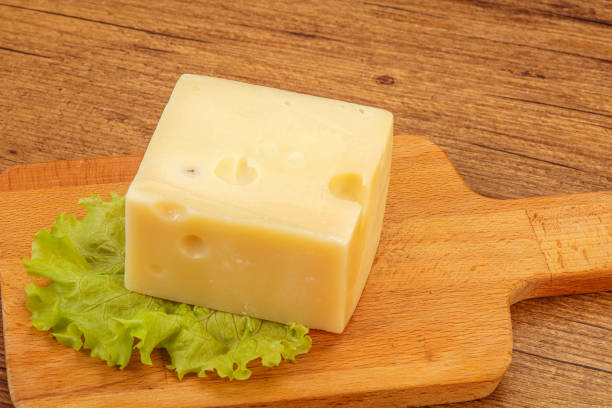 istock Emmental cheese over wooden board 1254338138
