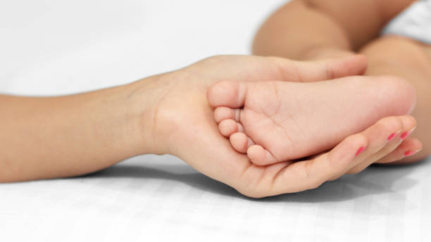 istock Baby foot in mohter’s hand 1254343477