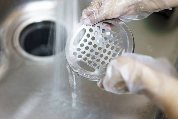 istock Women cleaning the kitchen sink with sponge 1254345575