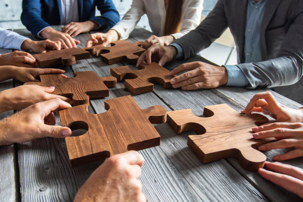 istock Business people and puzzle pieces 1254347550