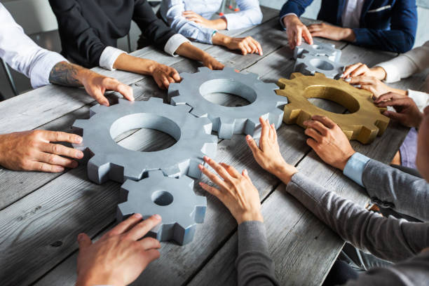 istock Business people joining gears 1254347564