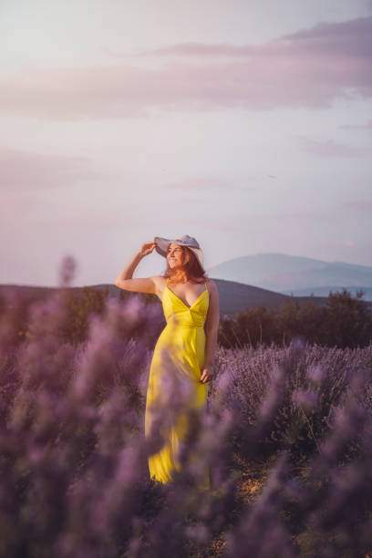 istock Young woman enjoying lavender field at sunset 1254350034