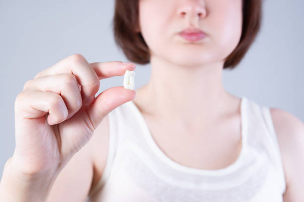 istock Wisdom tooth extraction, woman suffering from a toothache on gray background 1254350249
