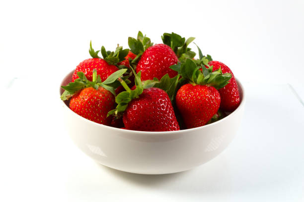istock A bowl with strawberries isolated on white background 1254351422