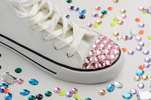 Bedazzled sneakers refashion. Glamorous design project with multicolor rhinestones for young girl.