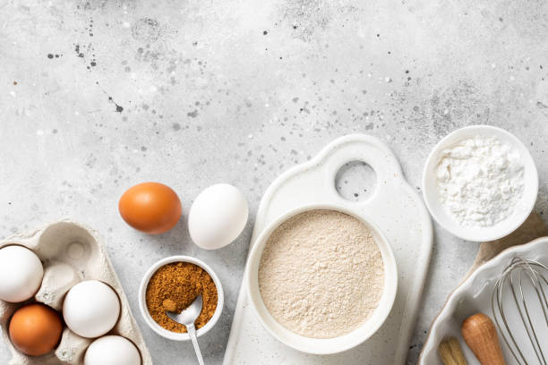 istock Ingredients for baking on a culinary background. Eggs, flour, cinnamon, sugar, soda on the kitchen table. Concept of preparation for baking. Top view with space for text 1254352939