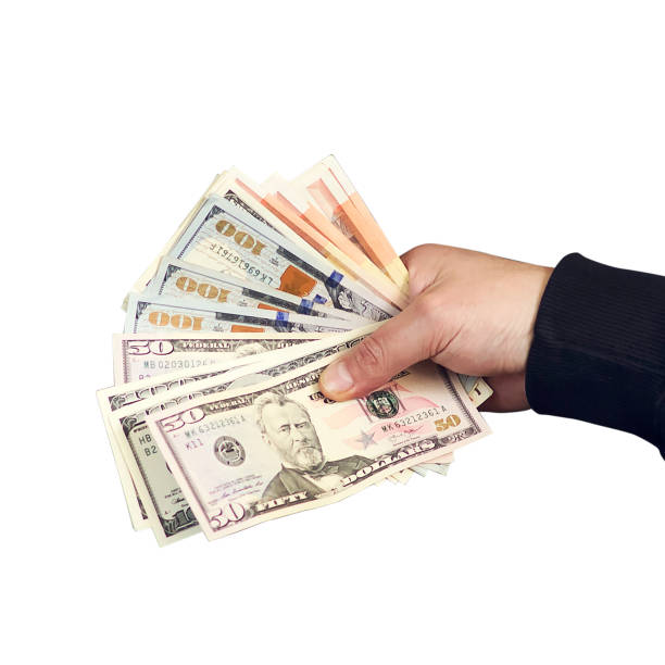 istock Dollar bills in a man's hand. Isolated on a white background. Business. 1254354670