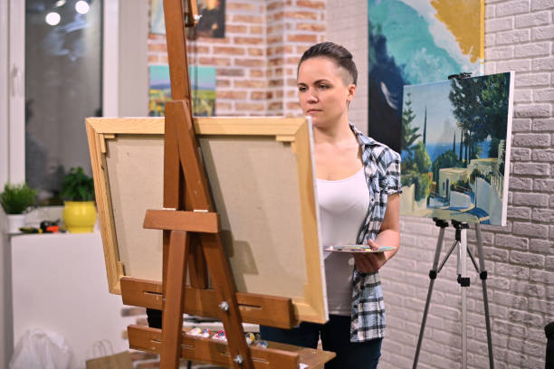 istock The artist works in her creative space, surrounded by paintings 1254354980