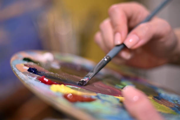 istock Color matching on a palette with oil paints. Selective focus 1254354985