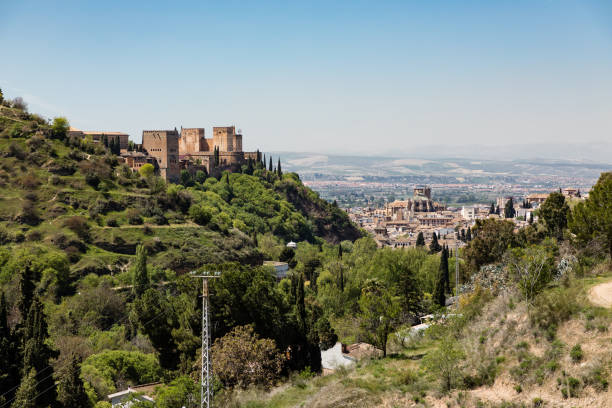 Alhambra Palace, Granada, Spain with the Torre de las Damas (The Ladies Tower) visible centrally, and the Sierra Nevada mountain range in the far background