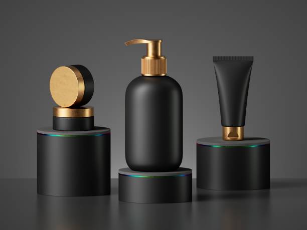 istock 3d render, black cosmetic bottles with gold caps isolated on black background. Brutal minimal design blank package mockup. Dispenser, jar, tube, vial. 1254358385