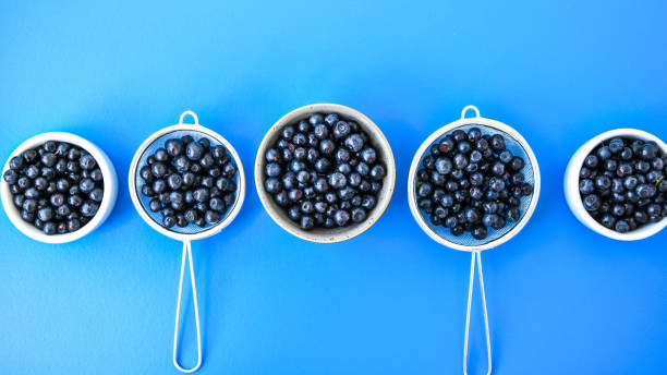 istock Berries. Blueberry. Forest Berries in a bowl on blue background. Background with selective focus. Copy space. 1254358545