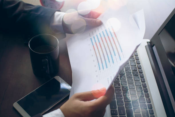 istock Businessman analyzing investment charts on the desk. 1254358755