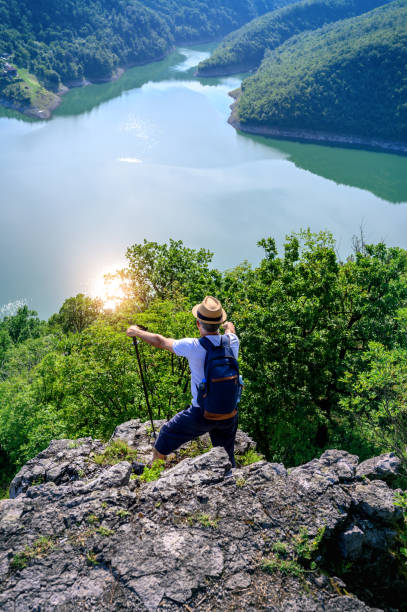 istock Hiker stands on a mountain top and admires view 1254360704