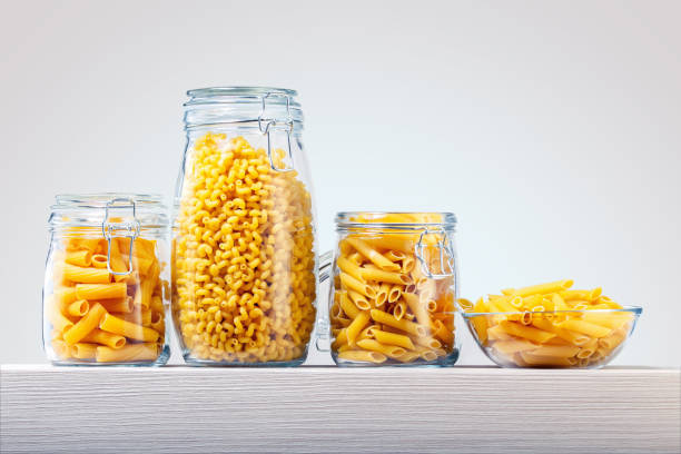 istock Different uncooked pasta on a wooden shelf with copy space. 1254360940