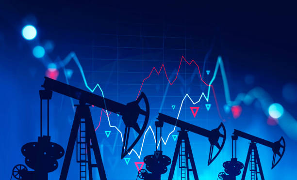 istock Oil pumps and falling graph over blue, crisis 1254362541