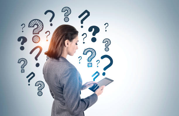 istock Businesswoman with tablet, question marks 1254364729