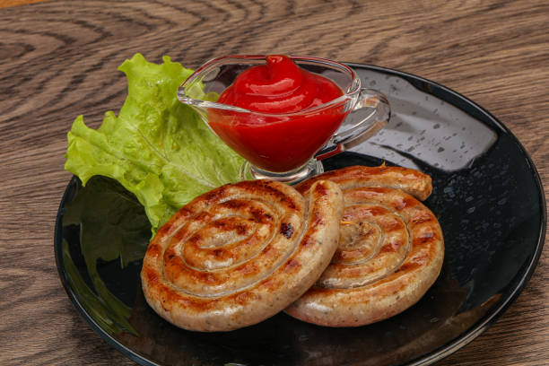 Grilled round pork tasty sausages with sauce