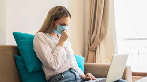 istock Woman coughing on sofa 1254366624