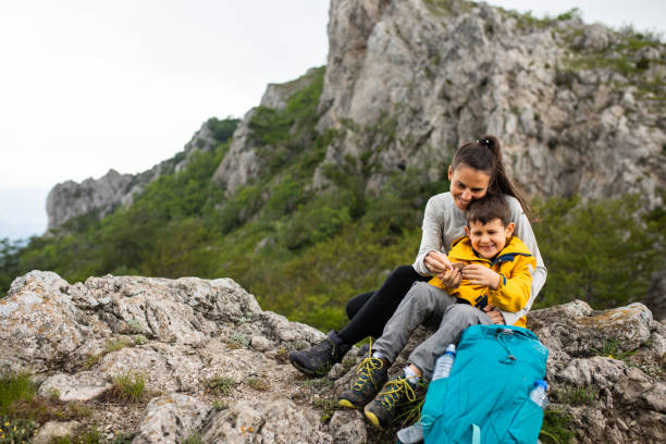 istock Mom and son playing while resting from hiking in the mountains 1254366682