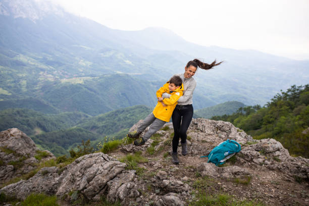 istock A young mom swinging her son on a mountain top 1254366697