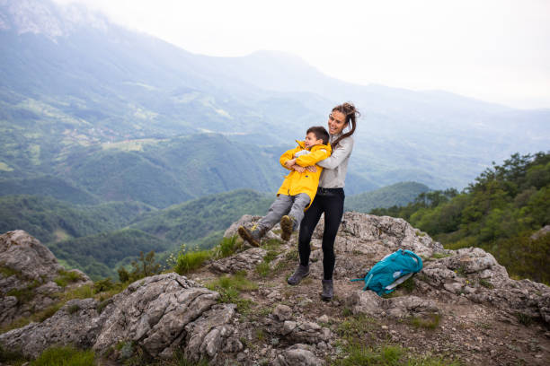 istock A young mom swinging her son on a mountain top 1254366698