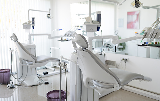 Horizontal color image of modern dental office with equipment.