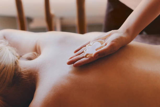istock Woman receiving a back massage with honey. 1254368919