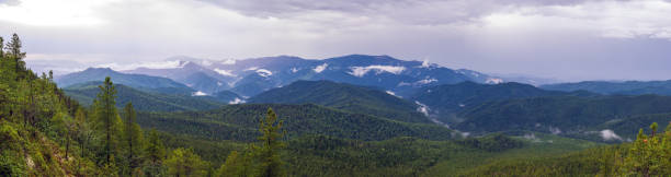 istock Sayan mountains view after rain. Low clouds and rain clouds. Panorama 1254371611
