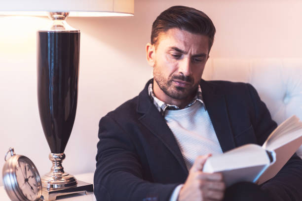 istock Home Portrait of a Caucasian Man Reading a Book 1254371853