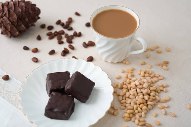 istock Stock image. A Cup of coffee with handmade chocolates. Cedar nut. 1254372531