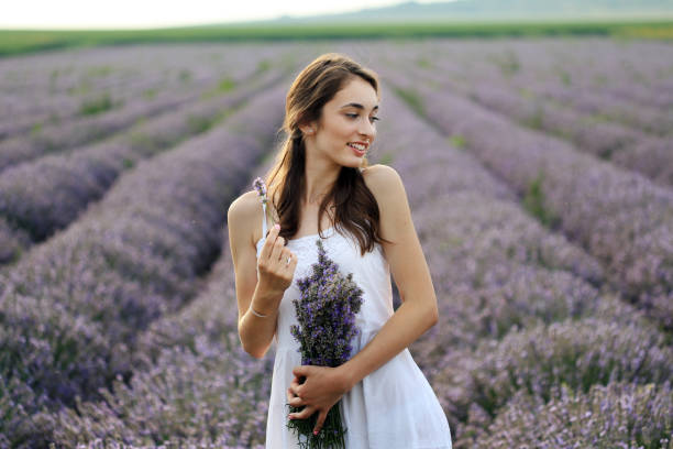 istock Young girl in lavender field holding bouquet 1254374000