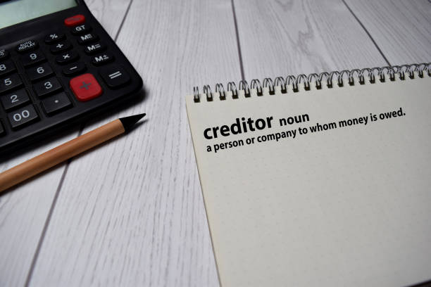 istock Definition of Creditor word with a meaning on a book. dictionary concept 1254375297