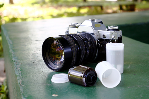 Old and vintage single lens reflex or SLR film camera at an outdoor park