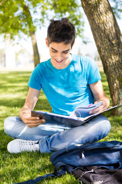istock Young student studying at the school garden 1254378194