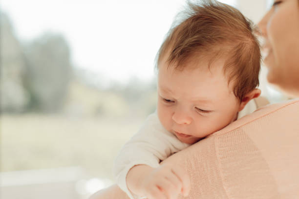 istock Young Mother holding newborn baby 1254378362