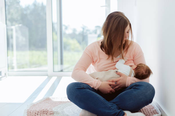 istock Young Mother breastfeeding newborn baby 1254378370