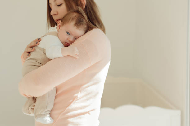 istock Young Mother holding newborn baby 1254378377