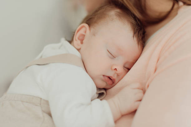 istock Young Mother holding newborn baby 1254378379