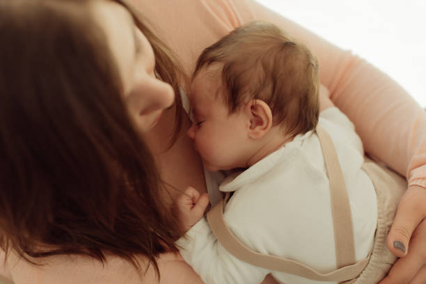 istock Young Mother holding newborn baby 1254378380
