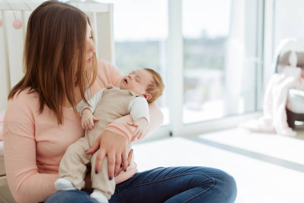 istock Young Mother holding newborn baby 1254378406