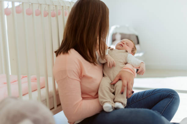 istock Young Mother holding newborn baby 1254378408