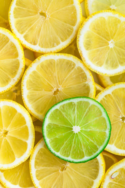 istock Lemon slices with one cut lime slice closeup 1254379518