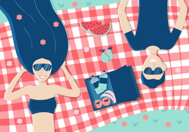 公園でチェック柄のピクニック毛布の上に横たわっている若いカップル - two pears点のイラスト素材／クリップアート素材／マンガ素材／アイコン素材