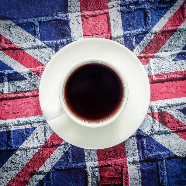 istock White cup of black coffee and British flag, Union Jack 1254382019