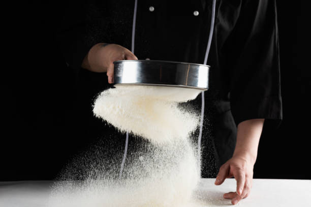 istock a dark background baker's hands sift white wheat flour over a sieve over 1254384924