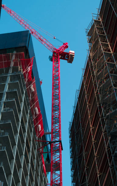 istock Red high crane surrounded by skyscrapers. 1254386908