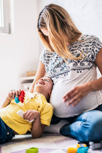 istock Playful pregnant mother and son 1254389002