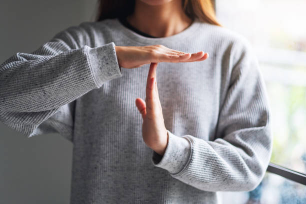 a woman making time out hand sign